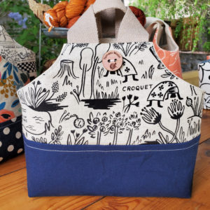 io tote with Alice in Wonderland canvas and a navy blue canvas base